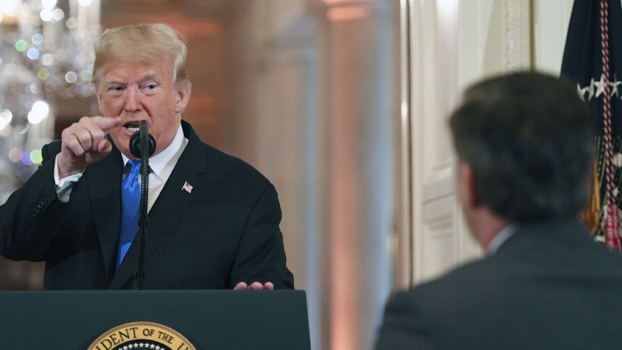 US President Donald Trump points to journalist Jim Acosta from CNN during a post-election press conference in the East Room of the White House in Washington, DC on November 7, 2018.