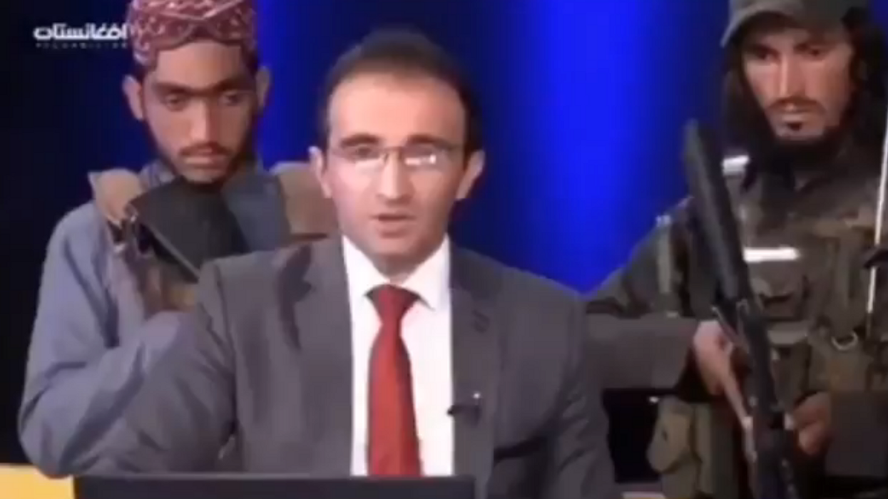 VIDEO: Afghan TV anchor tells residents 'don't be afraid' as Taliban fighters stand behind him with guns