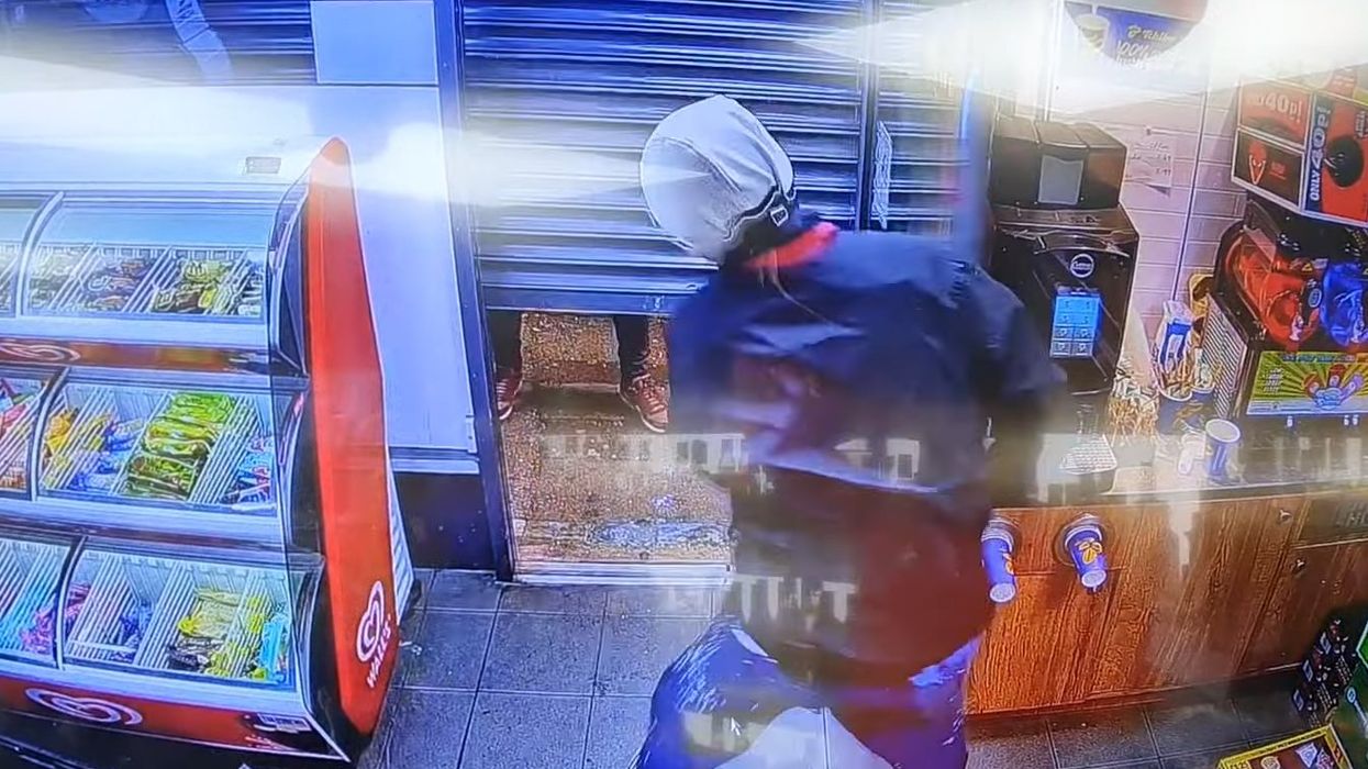 Video: British thief's 'Indiana Jones-style slide' to get past closing shutters fails. Stuck, he drinks to his misfortune.