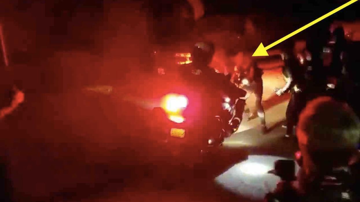VIDEO: Cop drives motorcycle into protester blocking his path, pushing her up road and knocking her down. And her comrades lose their minds.
