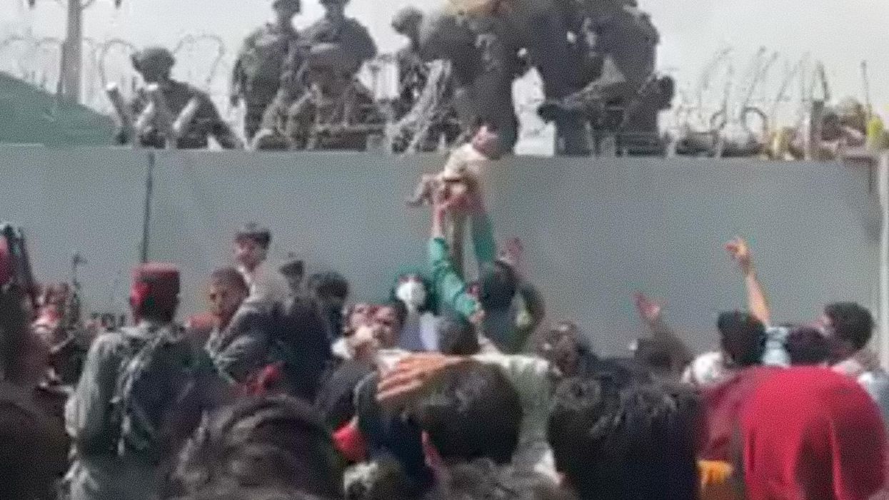 VIDEO: Desperate Afghani mothers throw their babies over barbed wire to allied troops in order to protect their children from Taliban