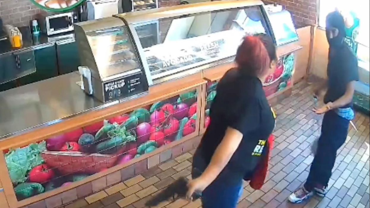 VIDEO: Female Subway employee fights off armed robbery suspect with his own gun