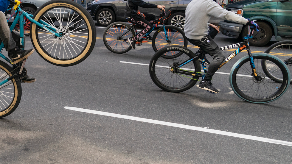 Video: Gang of thugs on bicycles surround, pummel lone victim in broad daylight until he's on his back, barely moving
