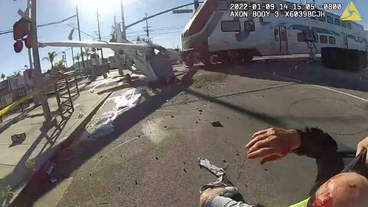 Video: Hero cops pull bloody pilot from crashed plane just seconds before speeding train smashes into it