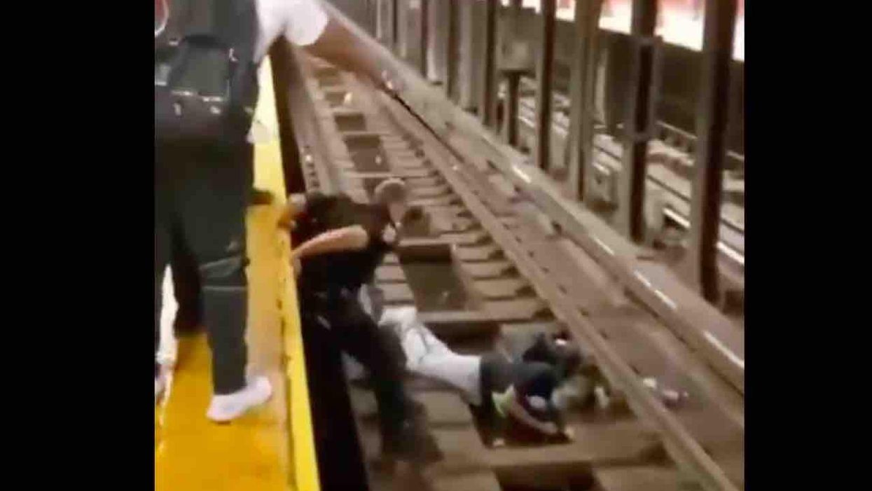 VIDEO: Hero NYPD officer jumps into action after sick man passes out and falls on subway tracks — and only seconds to spare with train approaching