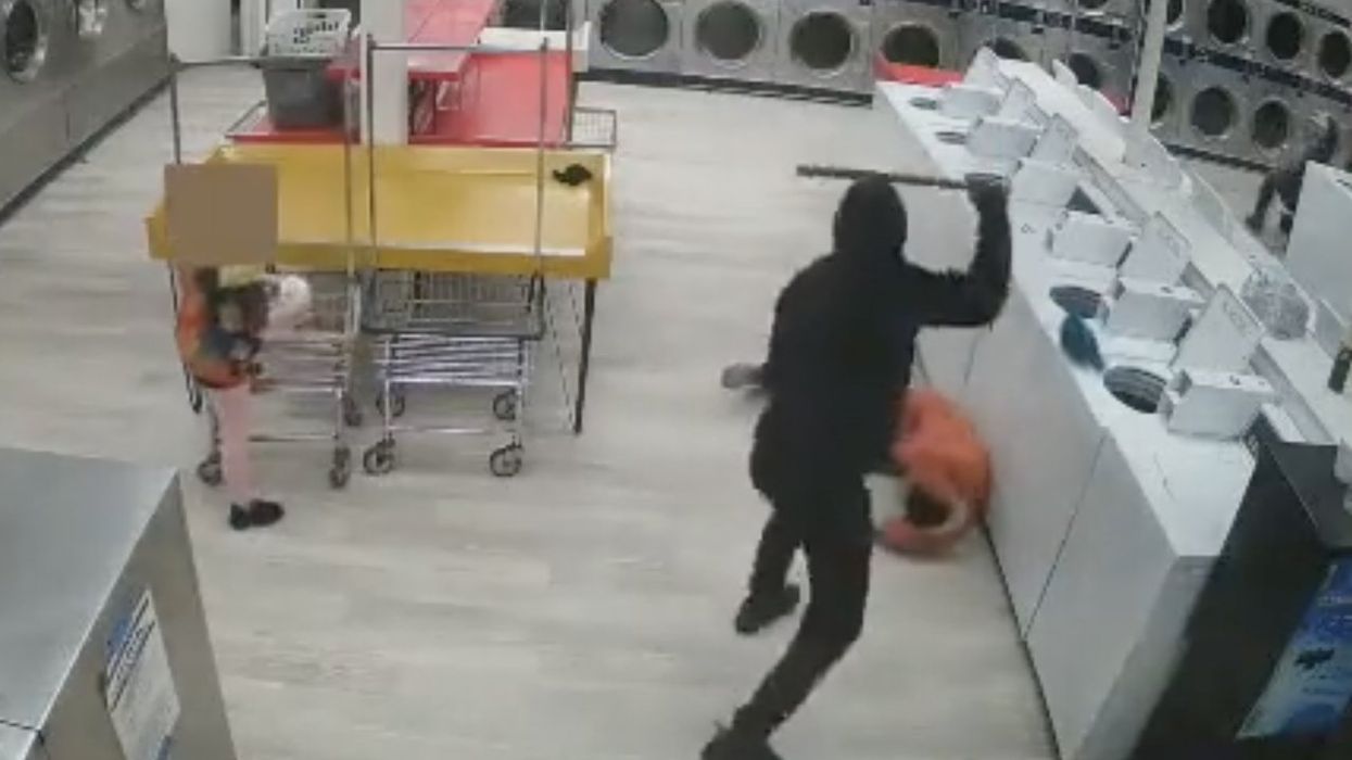Video: Hooded thug sneaks up behind man, repeatedly bashes him in head in unprovoked laundromat attack