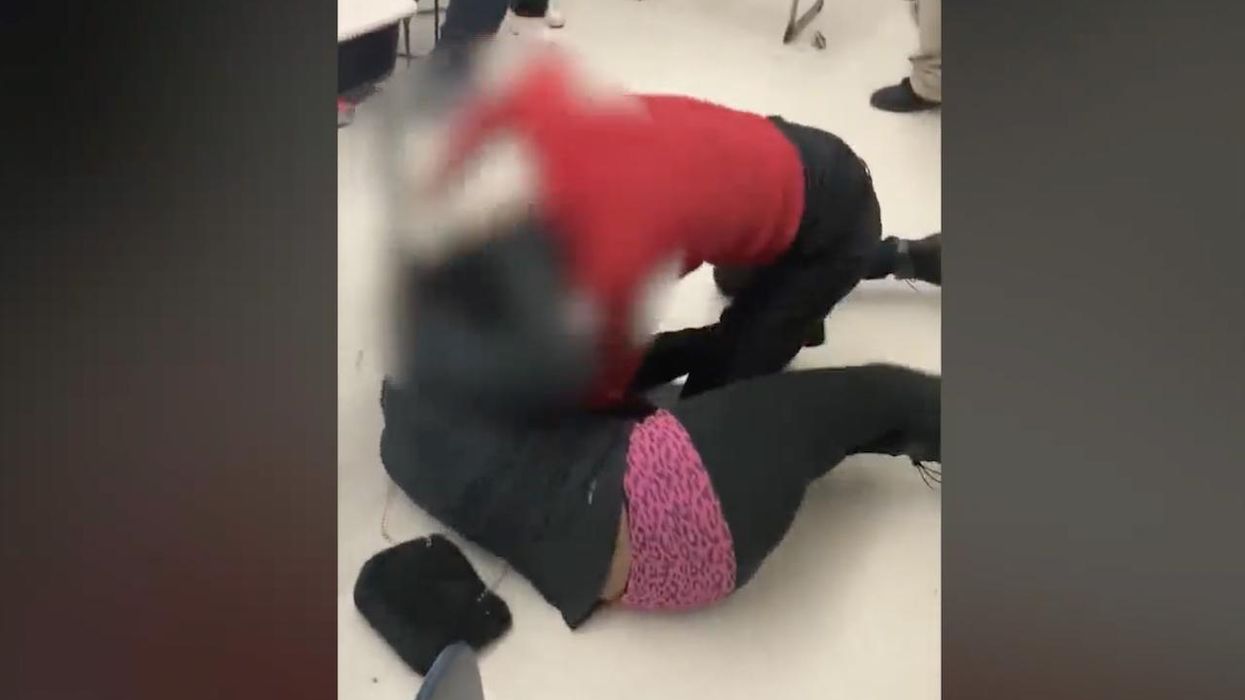 Video: Middle school teacher brawls with student in classroom. Punches thrown, hair pulled, bodies hit floor as young onlookers hoot and holler.
