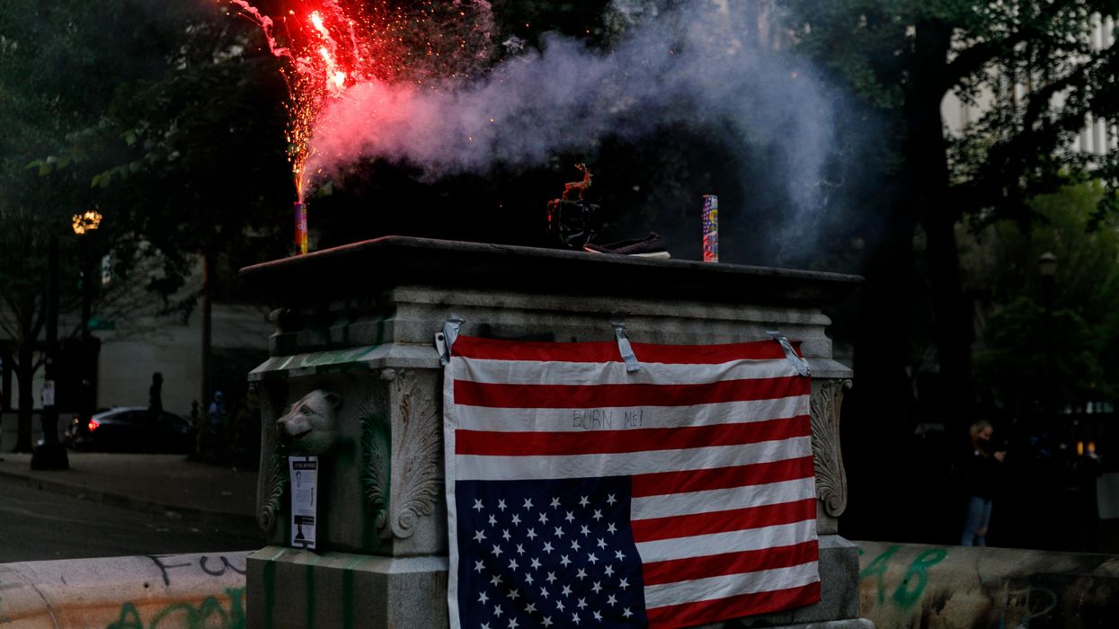 Video: Portland rioters bent on burning police precincts come for neighborhoods; US flag-caped woman intervenes