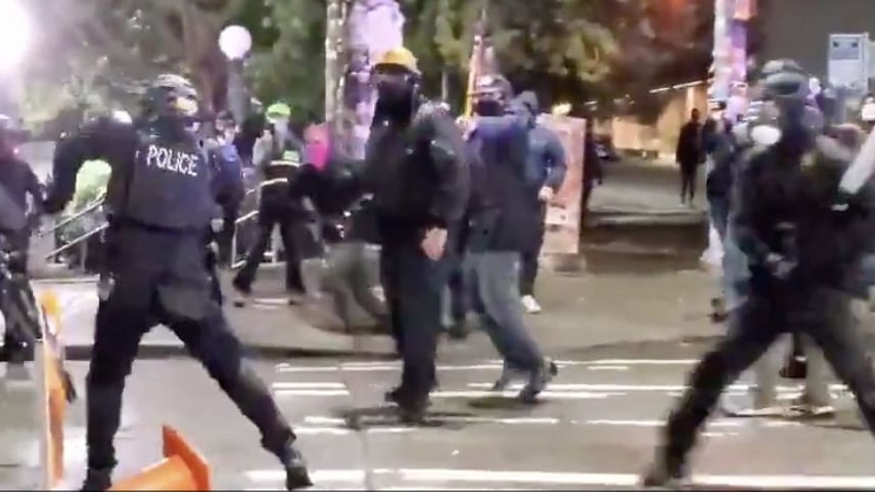 VIDEO: Rioter hits Seattle police officer in back of head with metal baseball bat, explosives thrown at cops