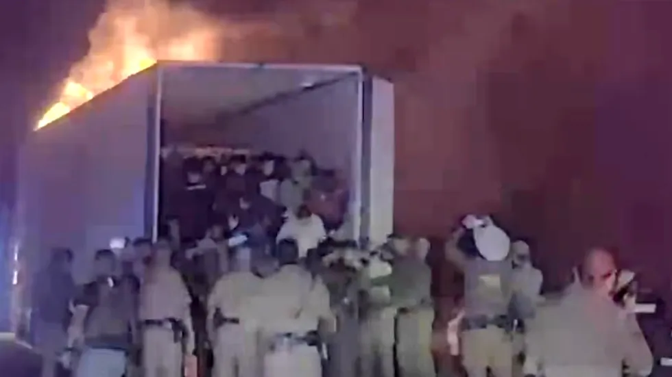 Video shows police PULLING 39 illegal aliens from tractor trailer that caught FIRE while fleeing from police