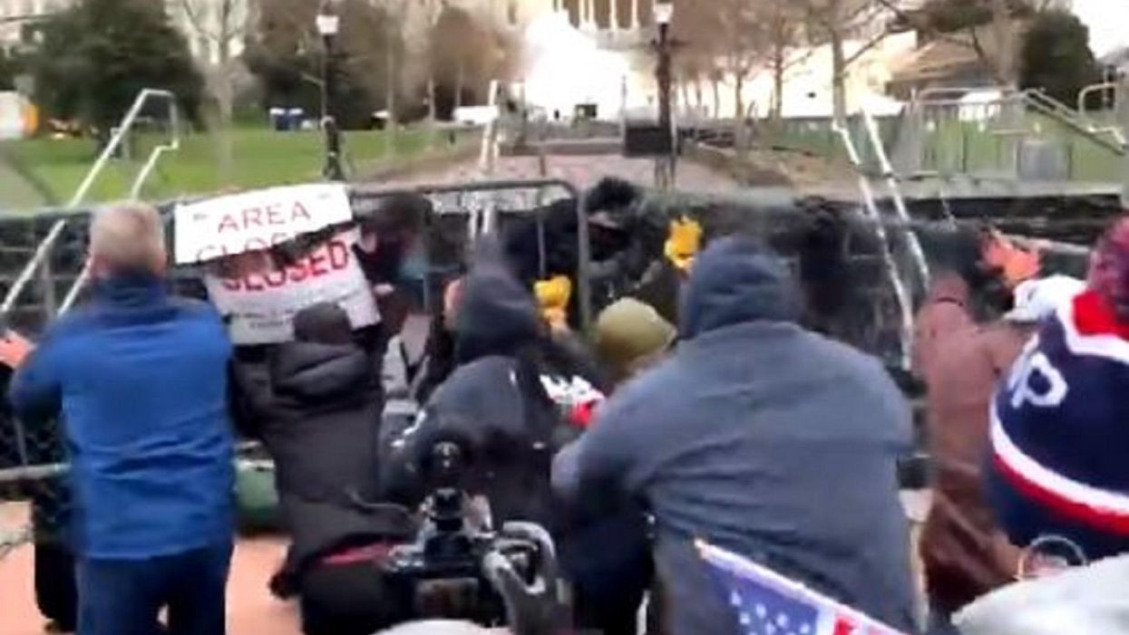 Video shows protesters overwhelming police, pushing down barrier in front of US Capitol as siege begins