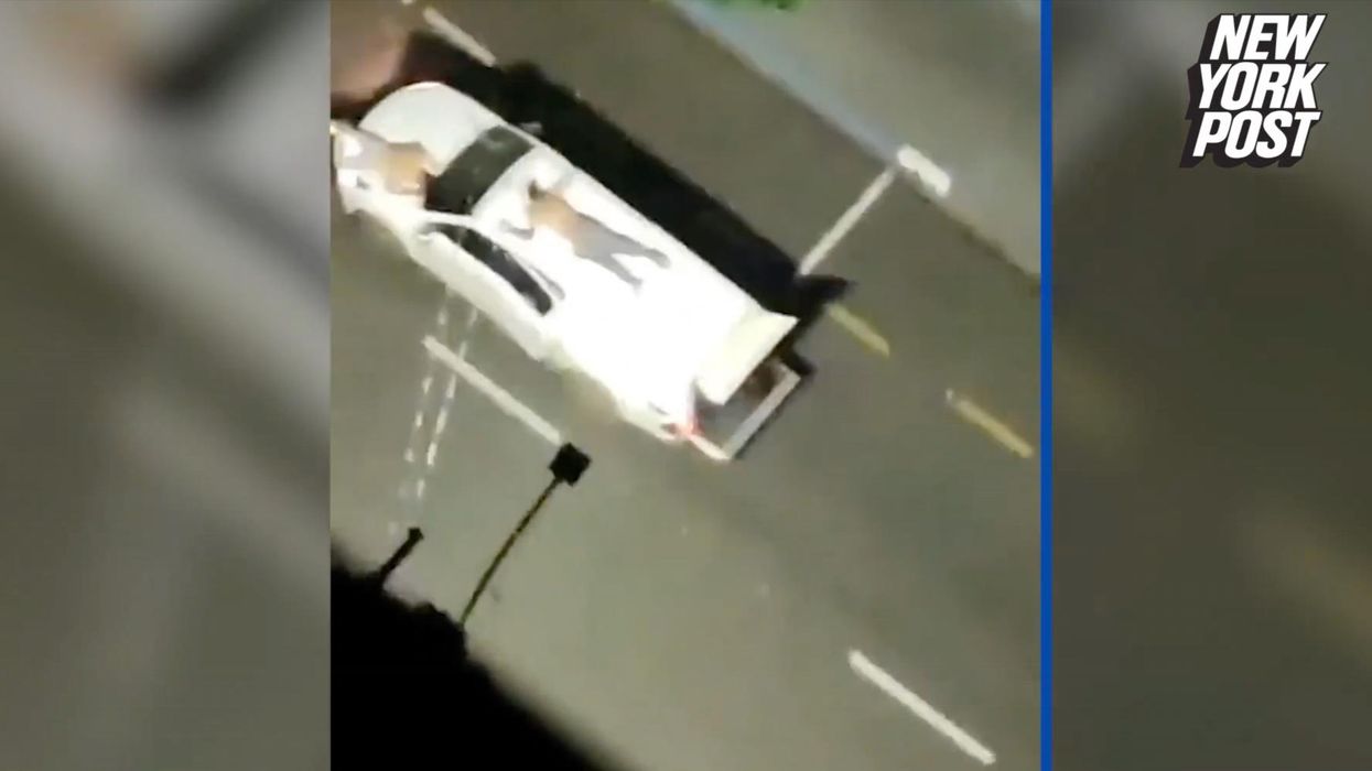 Viral video captures footage of roving bands of heavily armed bank robbery suspects with hostages strapped to getaway cars as 'human shields'