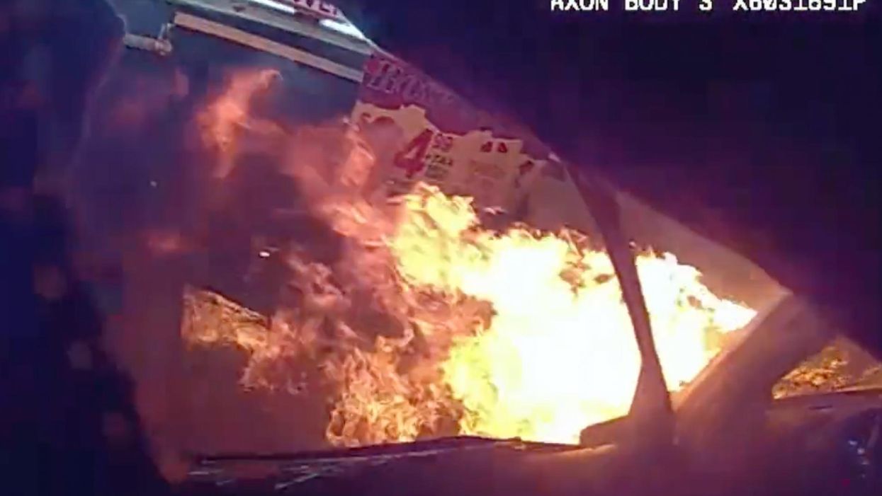 'When seconds matter': Bodycam footage shows hero police officer dashing to rescue trapped driver from fiery vehicle