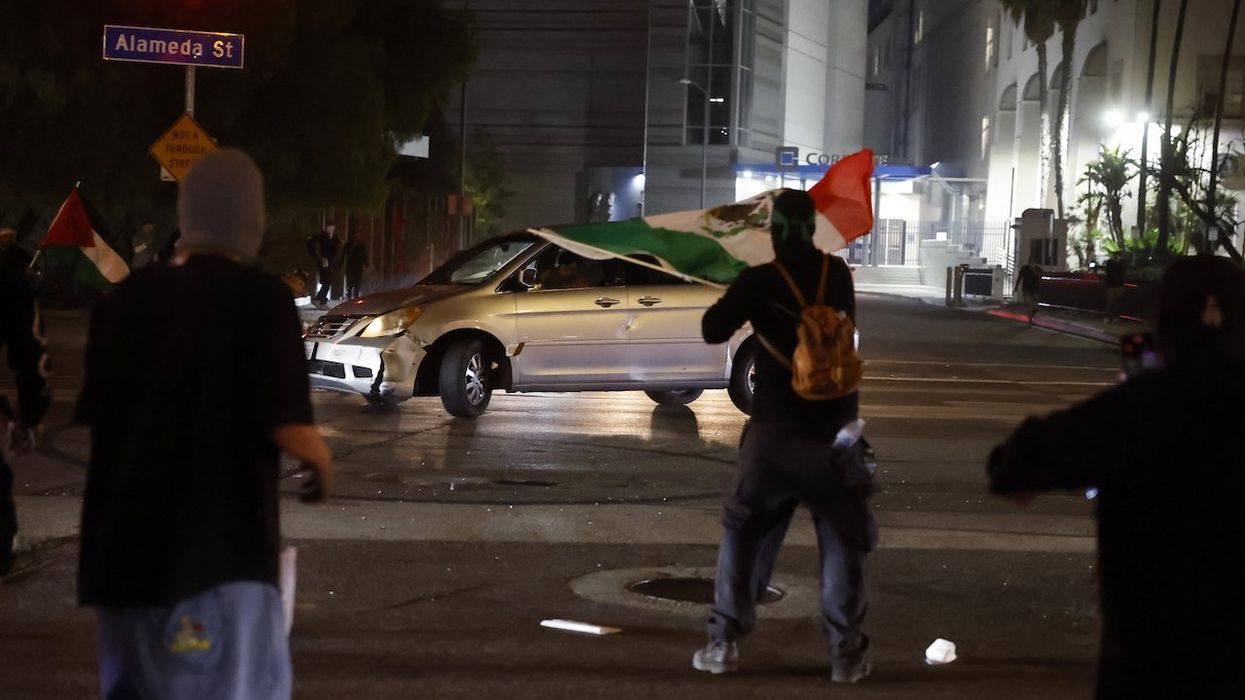 Why did unhinged LA minivan driver do 'street takeover' donuts amid rioting and get pelted by protesters?