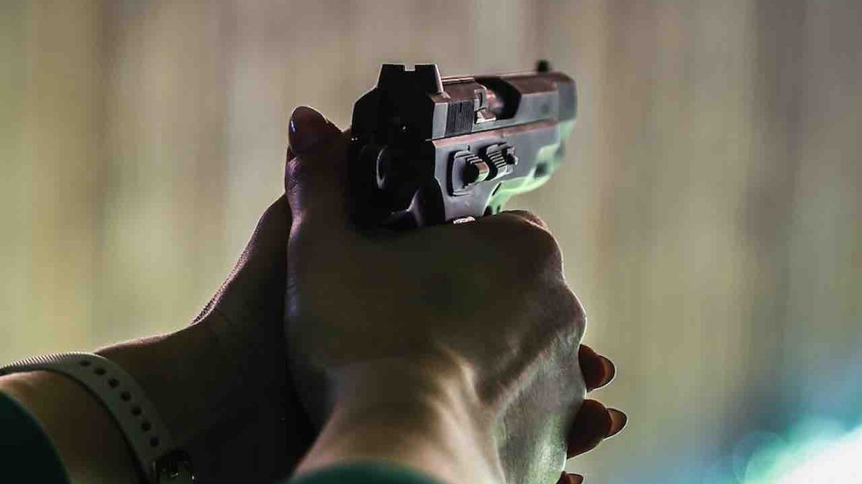 Wife reportedly sees man drive through her yard, exit car, force her husband to ground, and point gun at his head. So she grabs her own gun and ends threat permanently.