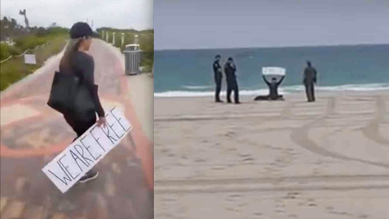 Woman holding 'We Are Free' sign while sitting on beach dragged away by cops
