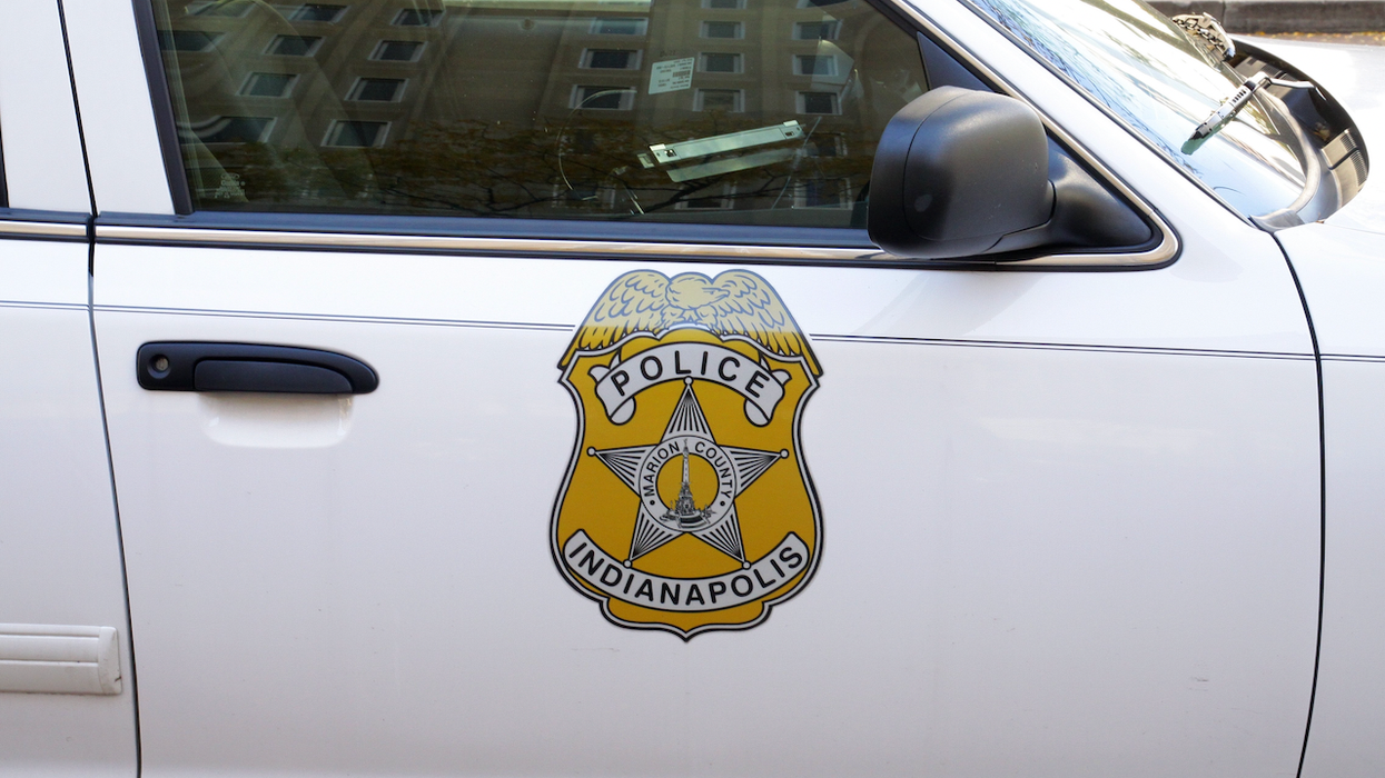 Woman stops car near cops, gets out, says male in car was holding her at gunpoint. Suspect points gun at cops, who open fire.